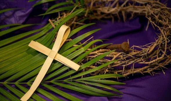 Cross made from palm, resting on a palm