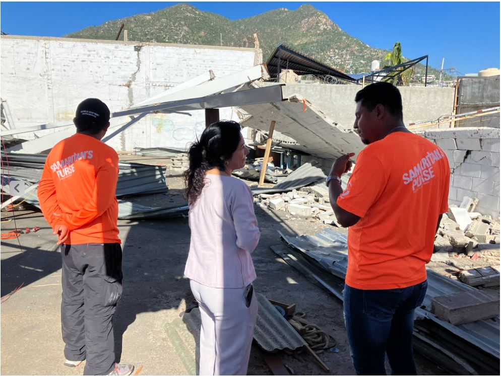 2 men and one woman discussing damage to church building